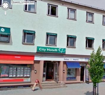 a large white building with a sign for a city hospital at Finlandia Hotel Lumiainen in Kankaanpää