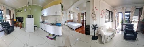 a kitchen with a sink and a refrigerator at Cozy Studio Apt Pool Free WIFI in Suva