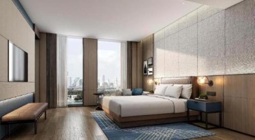 a bedroom with a bed and a large window at Four Points by Sheraton Kunshan in Kunshan