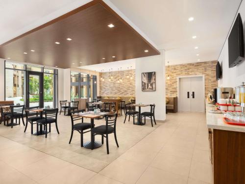 a dining room with tables and chairs in a building at ibis Styles Dubai Gold District in Dubai
