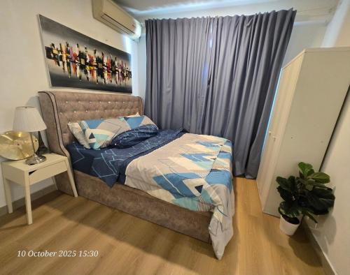 a bedroom with a bed and a window at HOMESTAY SUITE MENARA U2 , MSU , SEKSYEN 13 SHAH ALAM, Selangor in Shah Alam