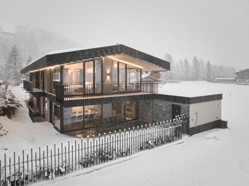 a house in the snow with a fence at Chalet White Pearl by MYALPS in Sölden
