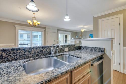 a kitchen with a stainless steel sink and granite counter top at Silver Seas 201 in Tybee Island