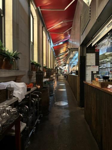a restaurant with a long corridor with tables and chairs at Elegant CBD Haven with City Views in Melbourne