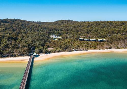 an aerial view of a bridge over a beach at Kingfisher Bay Resort in K'gari Island (Fraser Island)