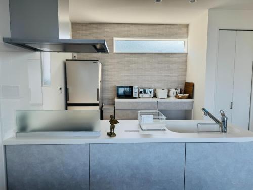 a kitchen with a sink and a refrigerator at Villa Blanche - Vacation STAY 31400v in Sumoto