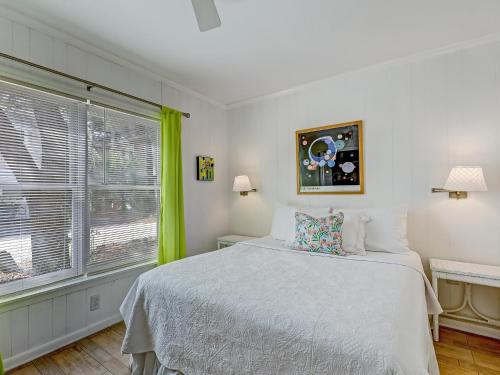 a bedroom with a bed and a large window at Coops Retreat Unit B in Tybee Island