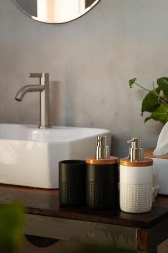 a bathroom with a sink and two rolls of toiletries at Hidden for Rest in Ban Huai Khai