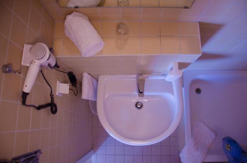 a bathroom with a toilet and a blow dryer on the wall at Rosenhof am Main in Offenbach