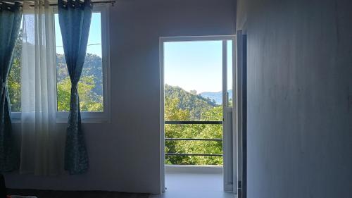 an open door with a window in a room at Sayatri stay in Karsiyang