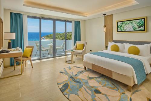 a bedroom with a bed and a view of the ocean at Chancellor Hotel Boracay in Boracay