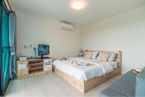 a bedroom with a large bed and a television at ม่อนล้านวิว ม่อนแจ่ม in Ban Pong Khai Tai