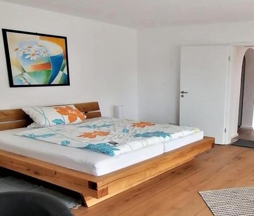 a bed with a wooden frame in a room at Ferienwohnung Leute in Tengen