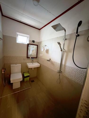 a bathroom with a shower and a sink at Baron Nilwella in Dickwella