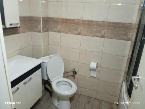 a small bathroom with a toilet and a sink at FushKosov in Kosovo Polje