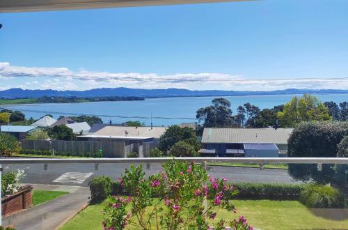 a view of the water from the balcony of a house at Lakaz Beach house in Omokoroa