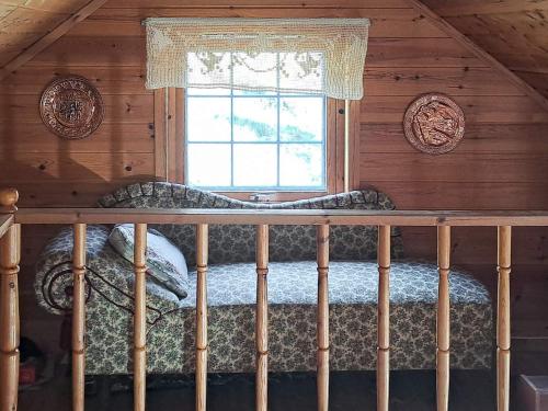 a bedroom in a log cabin with a window at 6 person holiday home in Åkra-By Traum in Kyrping