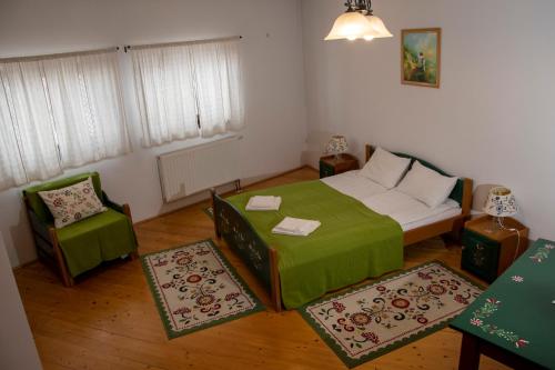 a room with a bed and a chair in it at Amadé Pension in Siculeni