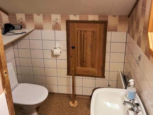 a small bathroom with a toilet and a sink at 7 person holiday home in STRYN-By Traum in Stryn