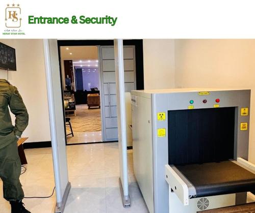 a soldier in uniform standing next to a machine at Herat Star Hotel in Herāt
