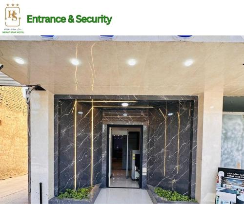 a entrance to a building with a black marble wall at Herat Star Hotel in Herāt