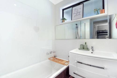 a white bathroom with a sink and a mirror at Lakeview Retreat Bonnie Doon - Sleeps 12 in Bonnie Doon