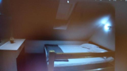 a small bedroom with a bed and a desk at Casa Dora in Sovata
