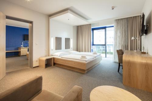 a bedroom with a bed and a large window at Hotel Global Inn in Wolfsburg