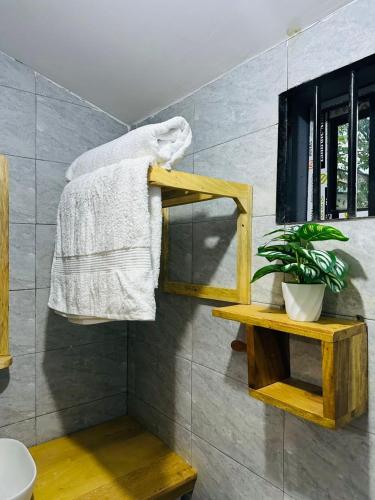 a towel hanging on a towel rack in a bathroom at J&T Homestay in Karatu