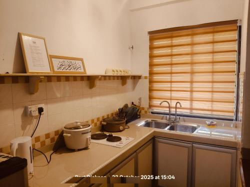 a kitchen with a sink and a counter top at Oceanwhite Homestay Corus in Port Dickson