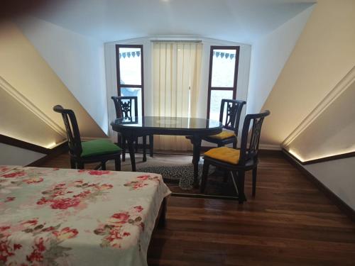 a room with a table and chairs and a table and a bed at Domore Lifestyle in Jetis