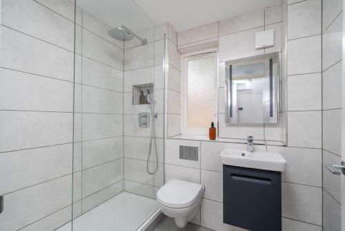 a bathroom with a shower and a toilet and a sink at 16 Guests, 4 Studios, Groups, Contractors, Stockwell SW9 in London