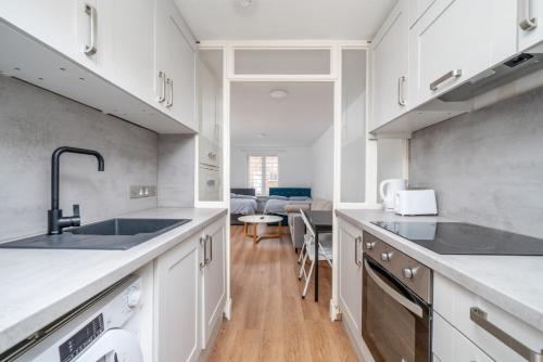 a kitchen with a sink and a counter top at 16 Guests, 4 Studios, Groups, Contractors, Stockwell SW9 in London
