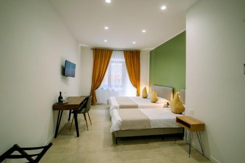 a hotel room with two beds and a desk at 4 Seasons Roma Trastevere in Rome
