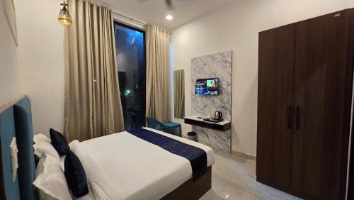 a hotel room with a bed and a window at JASMIN a luxury stay in Agra