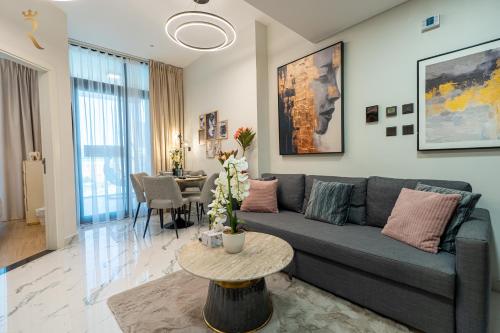 a living room with a couch and a table at Elegant 1BR Escape - Chic Al Maryah Cozy Retreat in Abu Dhabi