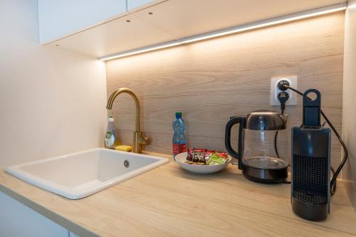 a kitchen counter with a sink and a blender at Skau Sky Park Ivory by Zaha Hadid 11 Floor 4 Tower Free Parking in Nivy
