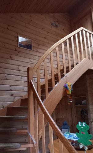 a wooden staircase in a log cabin at FeWo Wardersee in Rohlsdorf