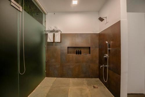 a bathroom with a shower and a shower stall at Casa Mili 3 BHK Villa with Private Swimming Pool By Aquatica Stays in Assagao