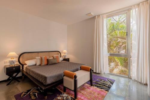 a bedroom with a bed and a large window at Casa Mili 3 BHK Villa with Private Swimming Pool By Aquatica Stays in Assagao