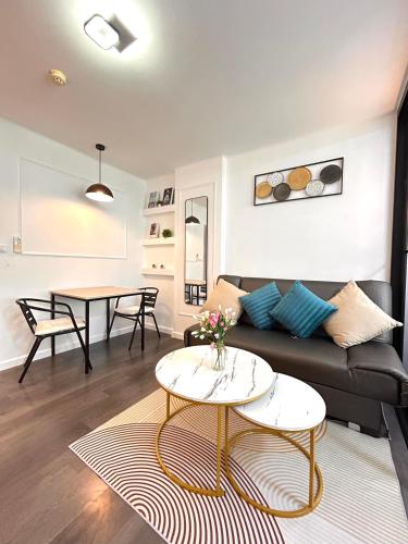 a living room with a couch and a table at Vibe Old Town 452 in Phuket