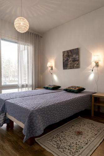 a bedroom with a bed with a blue comforter at Meritähti 104 in Kalajoki