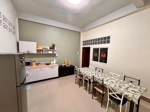 une salle à manger avec une longue table et des chaises dans l'établissement The Betong Life Guesthouse, à Betong