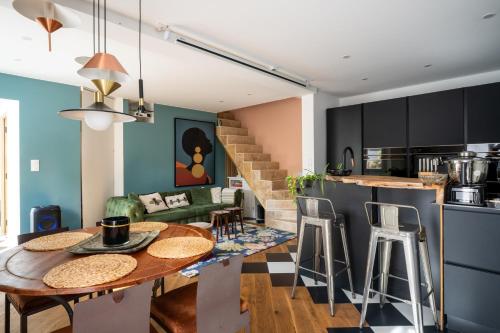 a kitchen and living room with a table and chairs at Lovely House in Besançon