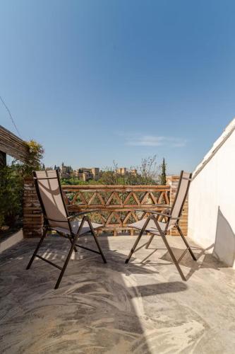 two chairs sitting on top of a roof at La Constanza Casa Cueva by ASH in Granada