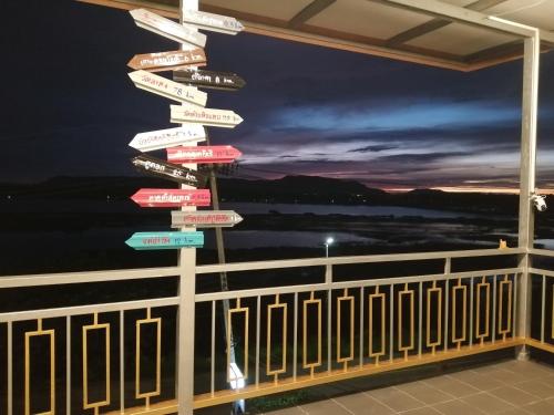 a street sign with many signs pointing in different directions at ชมวิว บึงโขงหลง in Ban Don Klang