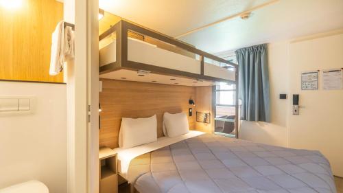 a bedroom with a bunk bed in a room at Premiere Classe Boissy St Leger in Boissy-Saint-Léger