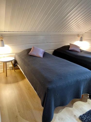 a bedroom with two beds and a table with lamps at Levinkruunu B Visit Levi in Levi