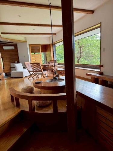 a living room with a table and some chairs at フォレスタ風影山荘 in Hanno