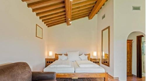 a bedroom with a bed and a couch in it at Tenuta Seripa in Sassetta